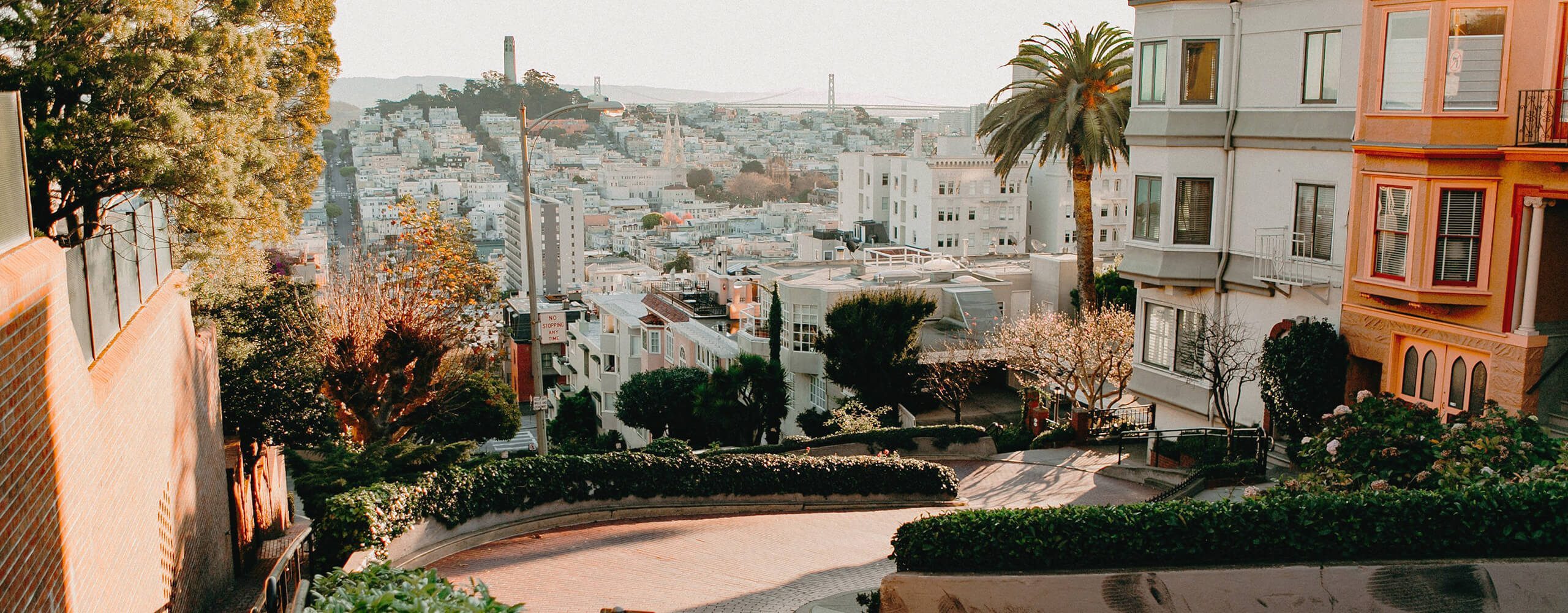 Populated area in San Francisco with view of mountains and the sea.