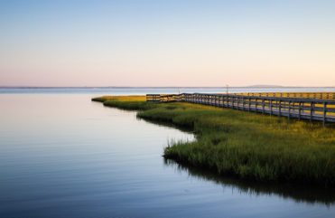 Estuary at sunset with dock