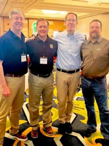 Men standing in a conference center